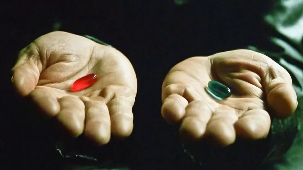 Red pill blue pill on hands