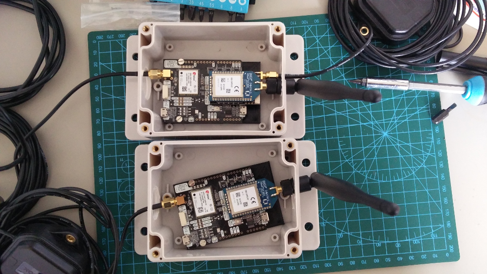 Project boxes with RTK modules and antennas attached